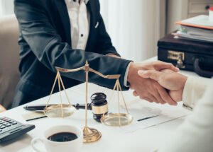 Businessman shaking hands to seal a deal with his partner lawyers or attorneys discussing a contract agreement